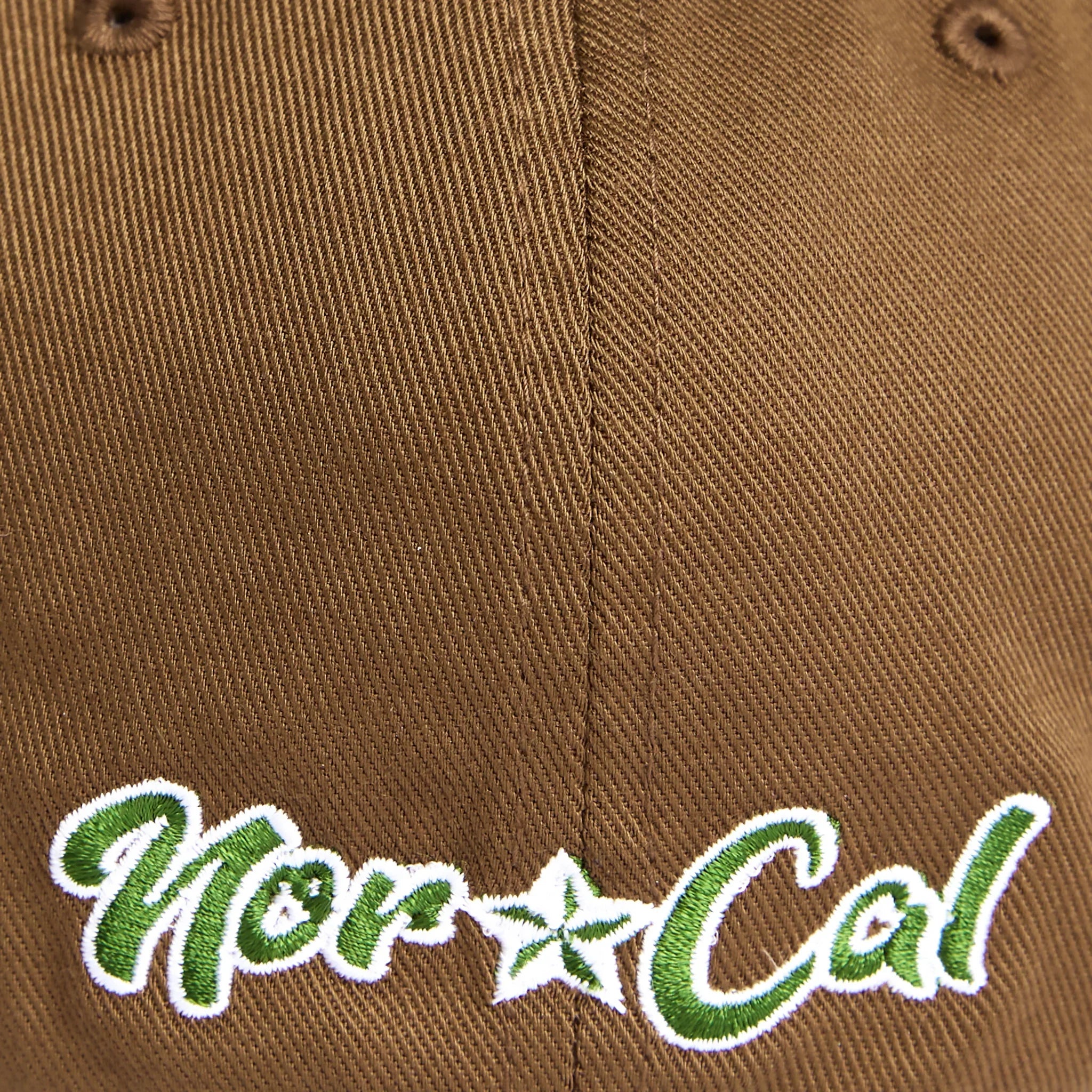 Brown cap with green and white embroidered Nor Cal script and star, reflecting Northern California style.