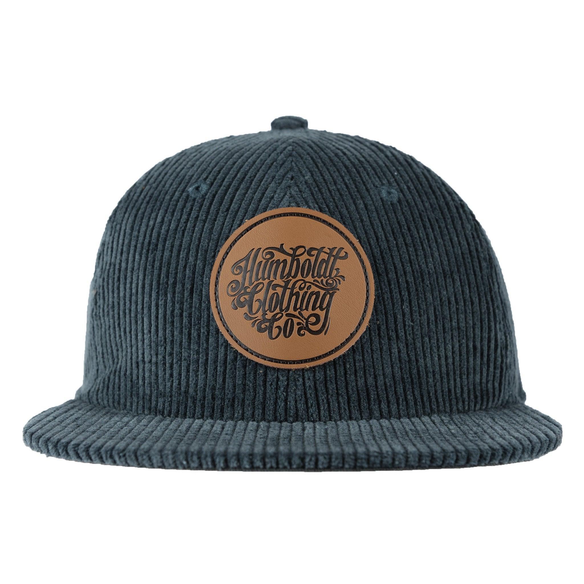 Dark corduroy snapback hat with leather Humboldt Clothing Co patch, blending outdoor and streetwear style
