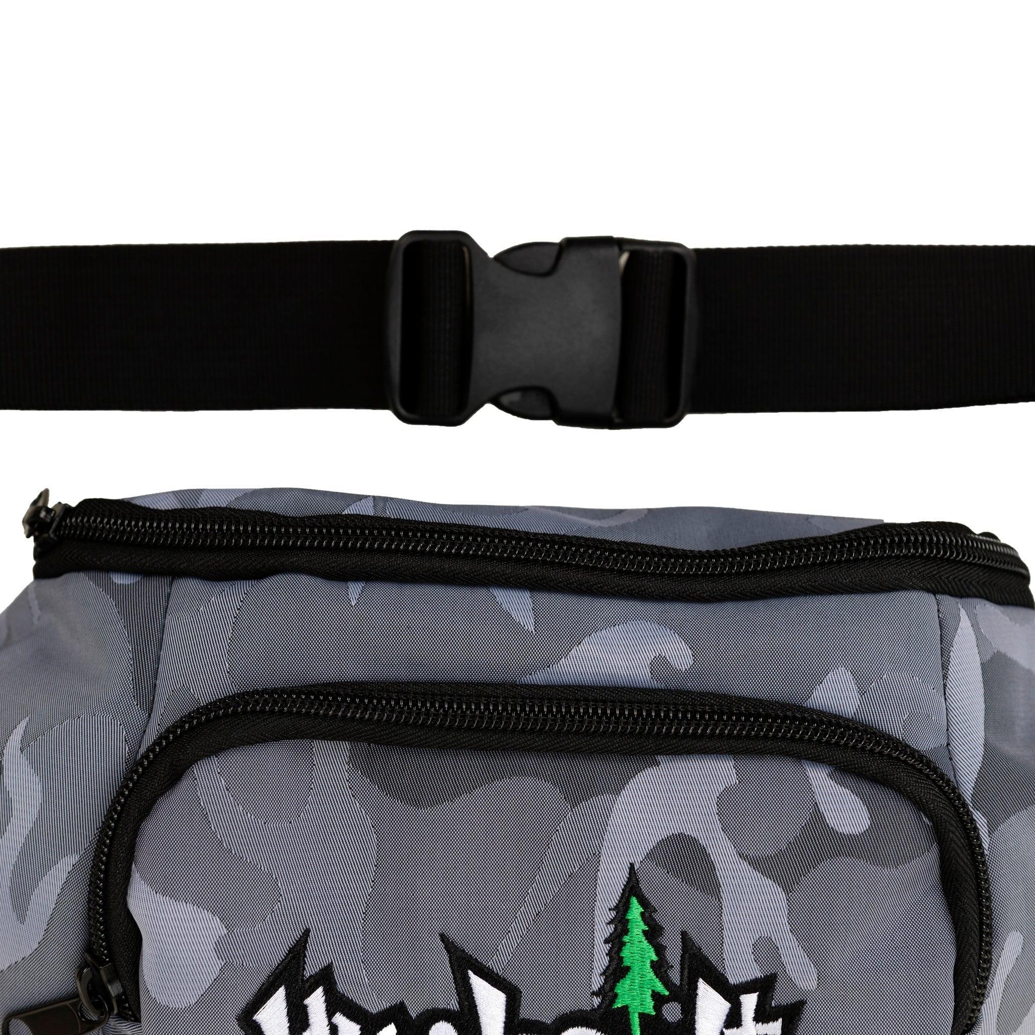 Gray camo fanny pack with green pine tree graphic, black zipper, and adjustable strap for outdoor adventures.