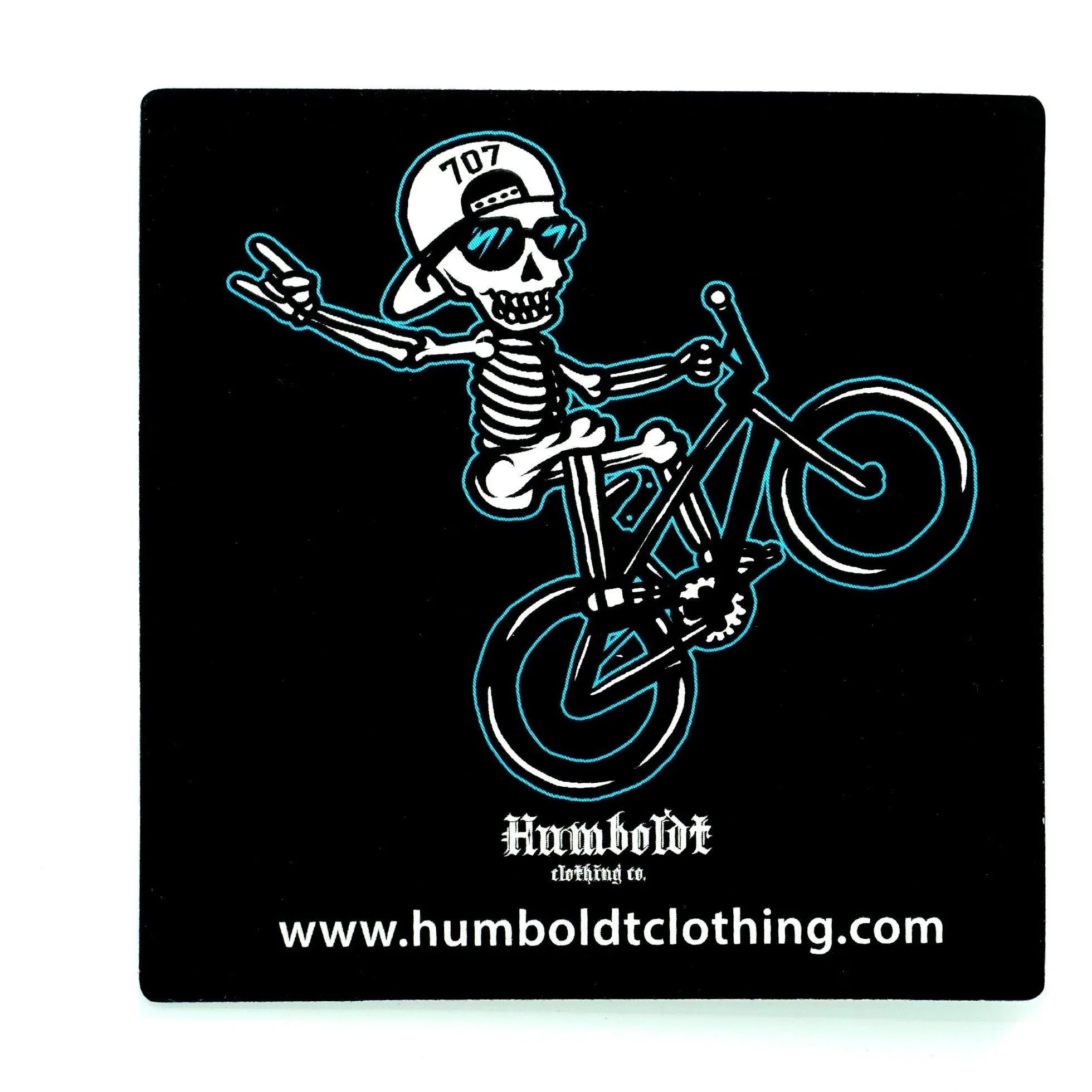 Skeleton riding bike in 707 hat, Humboldt Clothing Co. sticker with teal outline